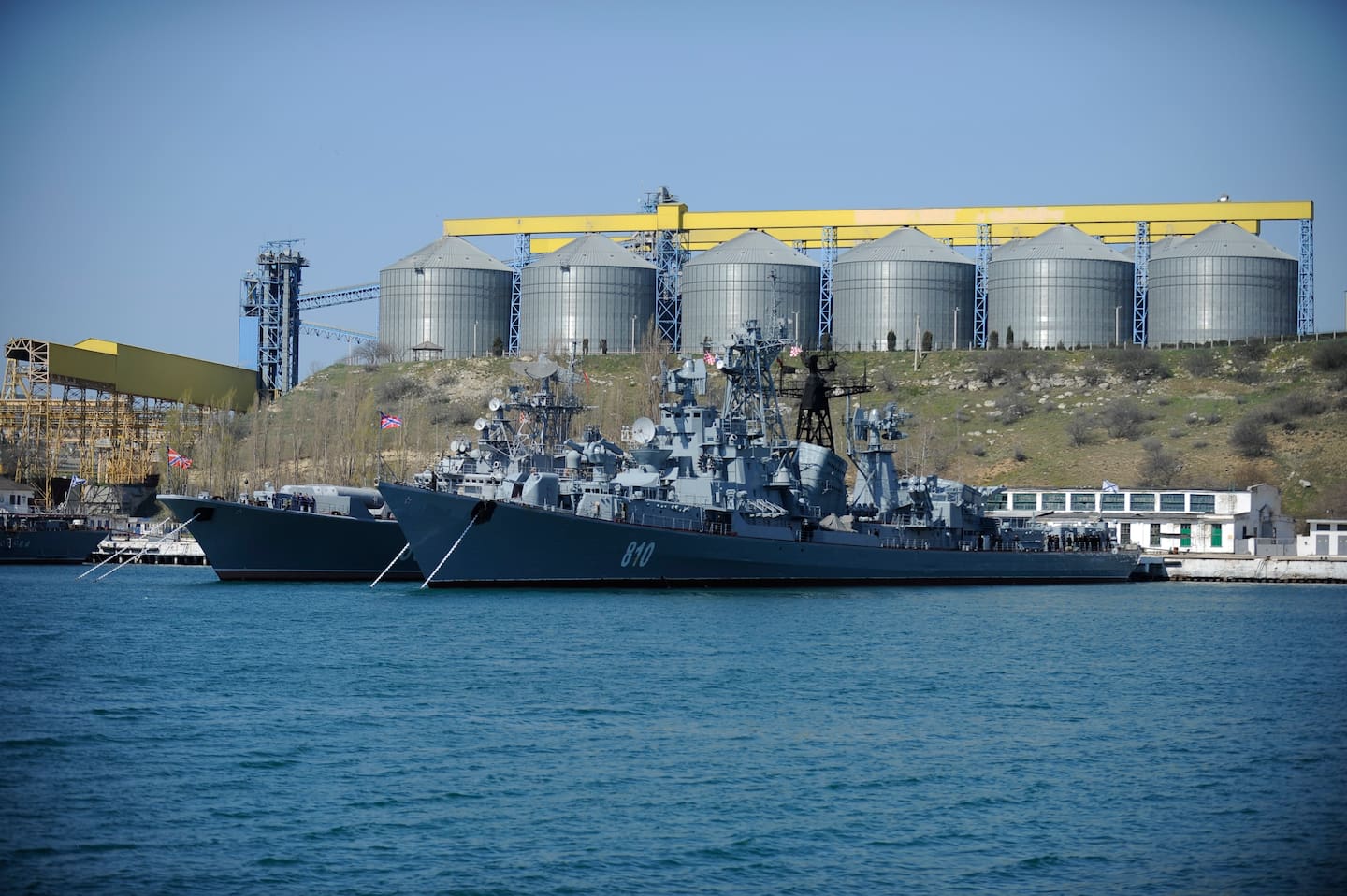 FILE - In this Monday, March 31, 2014 file photo Russian Black Sea fleet ships are anchored in one of the bays of Sevastopol, Crimea. With hundreds of new aircraft, tanks and missiles rolling off assembly lines and Russian jets buzzing European skies under NATOs wary eye, it doesnt look like Russias economic woes have had any impact on the Kremlins ambitious military modernization program. (AP Photo/Andrew Lubimov, File)